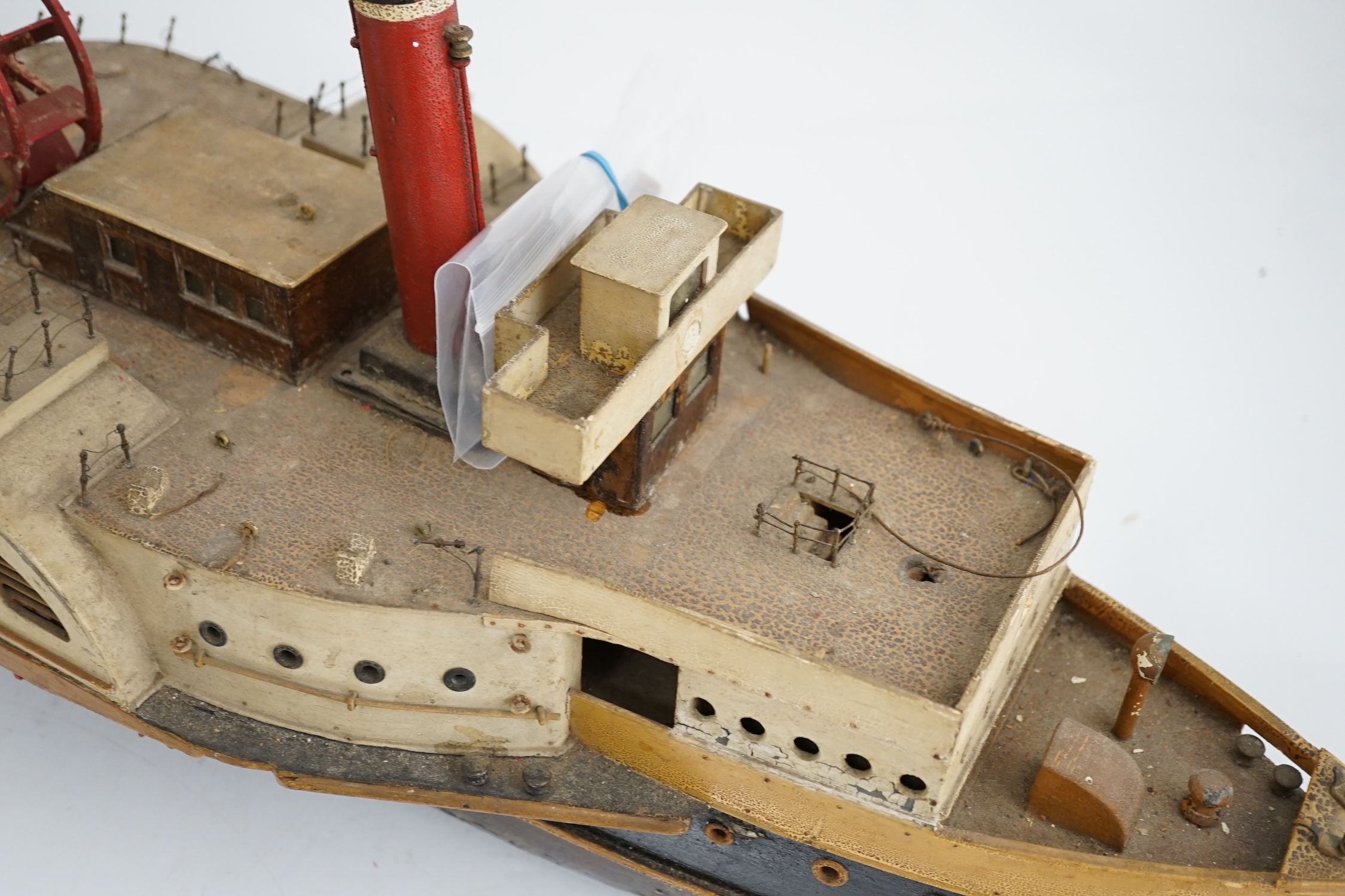 A wooden model of a paddle steamer, with a well detailed deck and with some age to the model, however now requiring some restoration, 80cm long